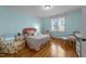 Bright bedroom with hardwood floors, natural light, and comfortable seating at 10540 Byrum Woods Dr, Raleigh, NC 27613