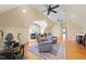 Bonus room with a ceiling fan, seating, exercise equipment, and hardwood floors at 10540 Byrum Woods Dr, Raleigh, NC 27613