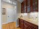 A stylish butler's pantry with granite countertops and glass-front cabinets at 10540 Byrum Woods Dr, Raleigh, NC 27613