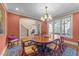 Formal dining room featuring hardwood floors, wainscoting, and chandelier lighting at 10540 Byrum Woods Dr, Raleigh, NC 27613