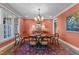 Formal dining room with large windows for natural light and charming decor at 10540 Byrum Woods Dr, Raleigh, NC 27613