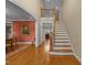 Elegant foyer with hardwood floors, staircase, and arched doorways at 10540 Byrum Woods Dr, Raleigh, NC 27613