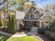 Beautiful stone and brick home with well-manicured landscaping and a welcoming front porch at 10540 Byrum Woods Dr, Raleigh, NC 27613