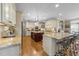 Open concept kitchen with large island, granite countertops, custom cabinets, and stainless appliances at 10540 Byrum Woods Dr, Raleigh, NC 27613