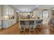 Spacious kitchen featuring an island with seating, stainless steel appliances, and custom cabinetry at 10540 Byrum Woods Dr, Raleigh, NC 27613