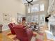 Bright living room with high ceilings, large windows, and fireplace at 10540 Byrum Woods Dr, Raleigh, NC 27613