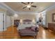 Main bedroom featuring hardwood floors, sitting area, and natural lighting at 10540 Byrum Woods Dr, Raleigh, NC 27613