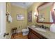 Elegant powder room boasting stylish vanity, mirror and hardwood flooring at 10540 Byrum Woods Dr, Raleigh, NC 27613