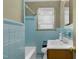 Bathroom featuring blue tiles, a bathtub, a sink with cabinet and a toilet at 1101 Nashville Rd, Rocky Mount, NC 27803