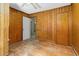 Wood-paneled bedroom with a doorway leading to another room at 1101 Nashville Rd, Rocky Mount, NC 27803