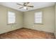 Bedroom with ceiling fan and two windows providing natural light at 1101 Nashville Rd, Rocky Mount, NC 27803