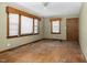 Spacious living room featuring vintage wood trim, hardwood floors, and multiple bright windows at 1101 Nashville Rd, Rocky Mount, NC 27803