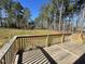 Spacious wooden deck overlooking a large, private backyard bordered by mature trees at 112 Wichita Way, Louisburg, NC 27549