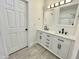 Well-lit bathroom with double sink vanity, marble countertop, modern fixtures, and wood-look flooring at 112 Wichita Way, Louisburg, NC 27549
