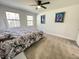 Bedroom with two windows, neutral walls, carpeted floors, and ceiling fan at 112 Wichita Way, Louisburg, NC 27549