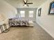 Neutral bedroom featuring two windows, a ceiling fan, and carpeted floors at 112 Wichita Way, Louisburg, NC 27549