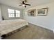 Bright bedroom featuring neutral carpet, a ceiling fan, and natural light from the double windows at 112 Wichita Way, Louisburg, NC 27549