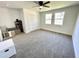 Bright bedroom with neutral carpet, closet, shelving, and two windows at 112 Wichita Way, Louisburg, NC 27549