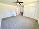Neutral carpeted bedroom with white walls, storage, closet, and entry door at 112 Wichita Way, Louisburg, NC 27549
