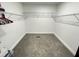 Walk-in closet featuring neutral carpeting and built in metal racks for organizing clothes at 112 Wichita Way, Louisburg, NC 27549