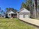 Charming single-Gathering home featuring a two-car garage, landscaped yard and a inviting front porch at 112 Wichita Way, Louisburg, NC 27549