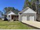 Beautiful exterior view of a craftsman style home with a covered porch, gray siding and a two-car garage at 112 Wichita Way, Louisburg, NC 27549