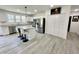 Bright kitchen with hardwood floors, white cabinets, stainless steel appliances and bar stool seating at 112 Wichita Way, Louisburg, NC 27549