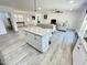 Open-concept kitchen with a central island, granite countertops, and modern appliances at 112 Wichita Way, Louisburg, NC 27549