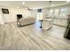 Bright, open-concept living room with hardwood floors, modern furnishings and a ceiling fan at 112 Wichita Way, Louisburg, NC 27549