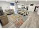 Bright living space with hardwood floors, two sofas, a ceiling fan, and an area rug at 112 Wichita Way, Louisburg, NC 27549