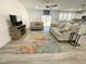 Bright living room boasts hardwood floors, a ceiling fan, and flows to a modern, open-concept kitchen at 112 Wichita Way, Louisburg, NC 27549