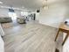 A bright, open living room with two sofas flows seamlessly into a modern, updated kitchen at 112 Wichita Way, Louisburg, NC 27549