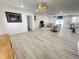 Open concept living area with hardwood flooring, neutral paint, modern lighting and comfortable furniture at 112 Wichita Way, Louisburg, NC 27549