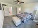 Bright main bedroom featuring plush carpeting, a ceiling fan, and modern decor at 112 Wichita Way, Louisburg, NC 27549