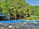 Community pool surrounded by lush greenery and mature trees for a relaxing atmosphere at 112 Wichita Way, Louisburg, NC 27549