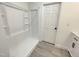 New bathroom with a bright white shower and a door leading into another room in the house at 112 Wichita Way, Louisburg, NC 27549