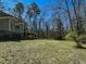 The backyard has mature trees and wooden deck off the home at 114 Twin Springs Ln, Angier, NC 27501