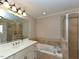 Spacious bathroom featuring a vanity with double sinks, soaking tub and glass shower at 114 Twin Springs Ln, Angier, NC 27501