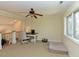 Open bonus room space features a ceiling fan, large window, and space for a desk at 114 Twin Springs Ln, Angier, NC 27501
