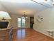 Bright dining room with hardwood floors, a decorative chandelier, and a large window offering scenic views at 114 Twin Springs Ln, Angier, NC 27501