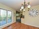 Elegant dining room with hardwood floors, a chandelier, and a view into the kitchen and a walk out deck at 114 Twin Springs Ln, Angier, NC 27501