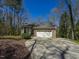 Front exterior featuring a two car garage, and well-maintained lawn at 114 Twin Springs Ln, Angier, NC 27501