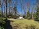 A well-maintained front lawn and a charming single-Gathering home nestled in a tranquil, wooded setting at 114 Twin Springs Ln, Angier, NC 27501