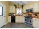 Bright eat-in kitchen featuring light cabinets, garden view from window, and entry to the back of the home at 114 Twin Springs Ln, Angier, NC 27501
