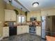 Bright eat-in kitchen featuring stainless steel appliances, light cabinets and a garden view from the window above the sink at 114 Twin Springs Ln, Angier, NC 27501