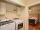 Convenient laundry room with washer and dryer; doorway leads to a bedroom at 114 Twin Springs Ln, Angier, NC 27501
