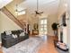 Spacious living room with vaulted ceilings, fireplace, and hardwood floors, bathed in natural light from large windows at 114 Twin Springs Ln, Angier, NC 27501