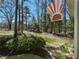 A garden and expansive yard offer a private space, set against a wooded backdrop and clear blue sky at 114 Twin Springs Ln, Angier, NC 27501