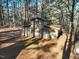 Rustic barn on wooded property with mature trees and fenced area at 1301 Flying Hawk Rd, Apex, NC 27523