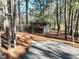 Charming barn nestled in a serene, wooded setting with gravel driveway at 1301 Flying Hawk Rd, Apex, NC 27523